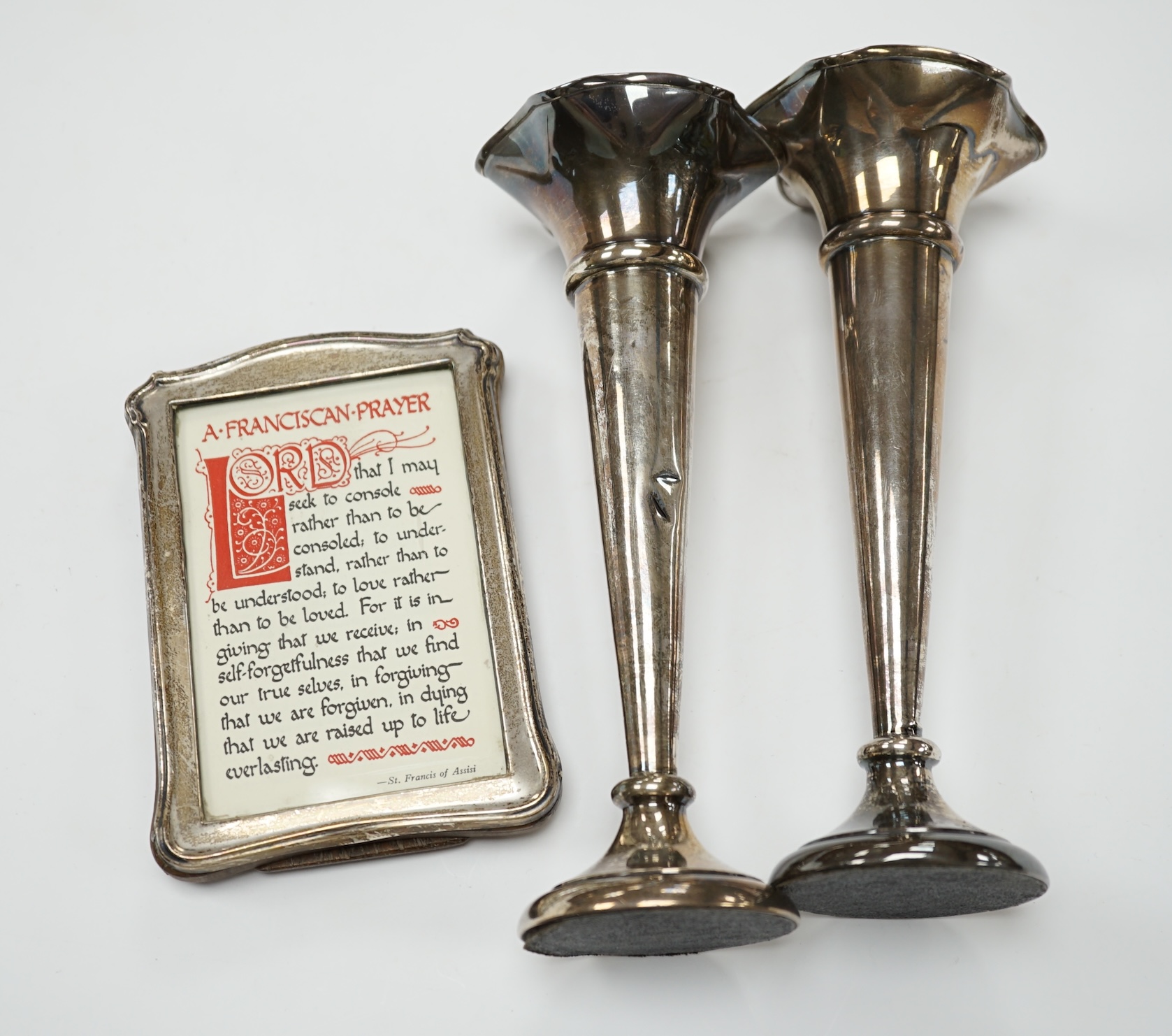 A pair of 1940's silver trumpet vases, 19.7cm, weighted, and a George V silver mounted photograph frame. Condition - poor